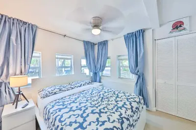 a bedroom with a bed and blue curtains at Student Villa House STR-2000 in Hollywood