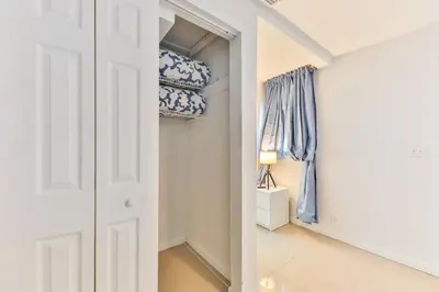 a walk in closet with blue and white towels at Student Villa House STR-2000 in Hollywood
