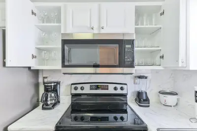 a kitchen with a stove and a microwave at Fantastic Family Nest for Joy STR-2310#1 in Fort Lauderdale