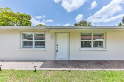 a white house with a white door and windows at Fantastic Family Nest for Joy STR-2310#1 in Fort Lauderdale