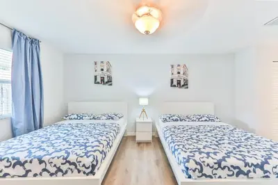 two beds in a room with white walls at Fort Lauderdale Family Bestseller in Fort Lauderdale