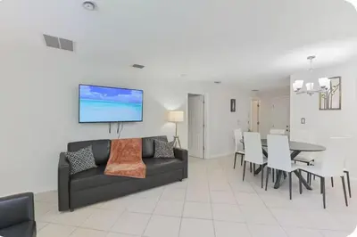 a living room with a couch and a dining room at Fort Lauderdale Family Bestseller in Fort Lauderdale
