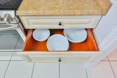 a drawer in a kitchen with white dishes in it at Hard Rock Family House in Fort Lauderdale
