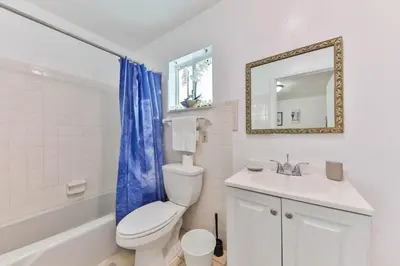 a bathroom with a toilet and a sink and a mirror at Lucky Family Charm STR-2750 in Hollywood