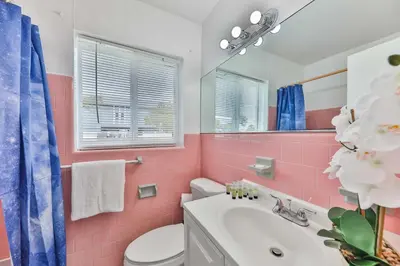 a pink bathroom with a toilet and a sink at Lucky Family Charm STR-2750 in Hollywood