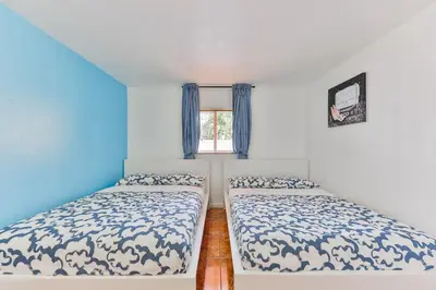 two beds in a small room with a window at Lucky Family Charm STR-2750 in Hollywood