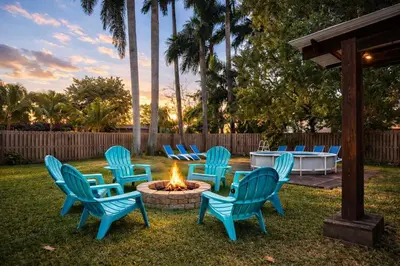 a group of chairs sitting around a fire pit at Cruise Family house STR-1761 in Fort Lauderdale