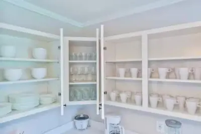a kitchen with white shelves with cups and dishes at Cruise Family house STR-1761 in Fort Lauderdale