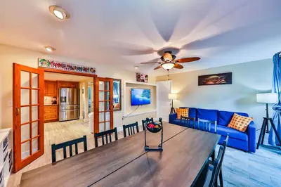 a living room with a blue couch and a table at Garden botanical Villa with jacuzzi in Hollywood