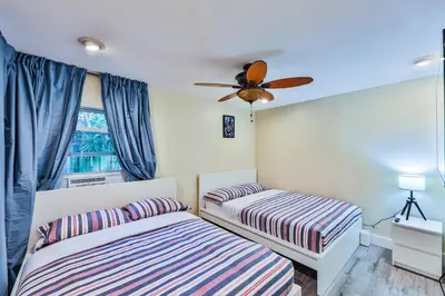a bedroom with two beds and a ceiling fan at Garden botanical Villa with jacuzzi in Hollywood