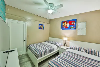 a bedroom with two beds and a ceiling fan at Garden botanical Villa with jacuzzi in Hollywood