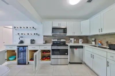 a white kitchen with a stove and a microwave at Jungle Happiness Villa STR-2651 in Hollywood