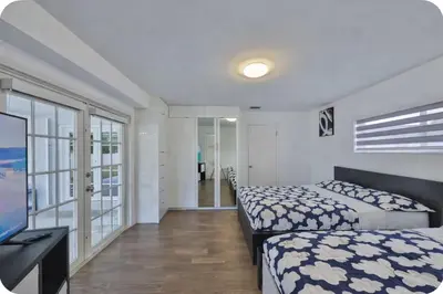 a bedroom with two beds and a flat screen tv at Jungle Happiness Villa STR-2651 in Hollywood