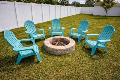 four blue chairs sitting around a fire pit at Jungle Happiness Villa STR-2651 in Hollywood
