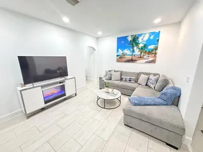a living room with a couch and a flat screen tv at Sunset Villa- 3 Bedroom 2 Bathroom -6 Beds in Miami