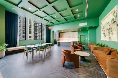 a lobby with green walls and tables and chairs at Urban Oasis Luxury Suite- Sky High Amenities in Miami