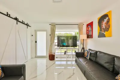 a living room with a couch and a television at Classy Family Stylish Swimming Joy in Hollywood