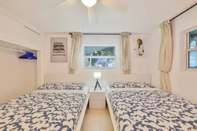 a bedroom with two beds and a window at Friday Family Feels Only in Hollywood