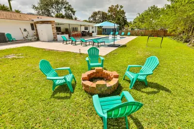 a group of chairs and a fire pit in a yard at A star is born villa in Hallandale Beach