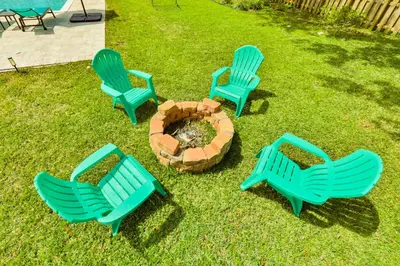 a group of chairs sitting around a fire pit at A star is born villa in Hallandale Beach