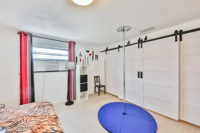 a bedroom with white cabinets and a blue table at Release your nature in Hallandale Beach