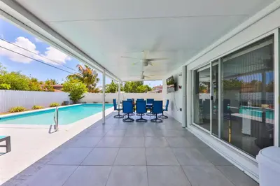 a house with a swimming pool and blue chairs at Up and down - flat Are boring villa in North Miami Beach