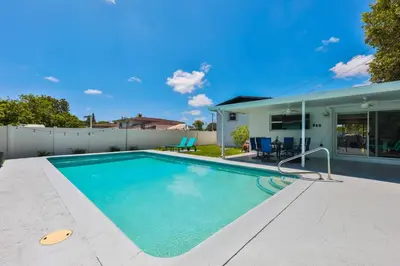 a swimming pool in the backyard of a house at Up and down - flat Are boring villa in North Miami Beach