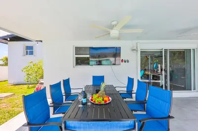 a dining room with a table and blue chairs at Up and down - flat Are boring villa in North Miami Beach