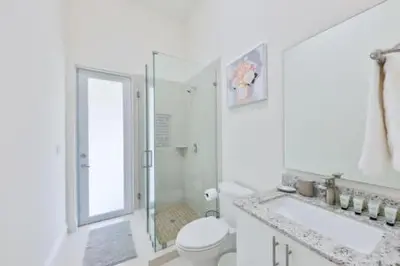 a white bathroom with a shower and a toilet and a sink at Luxury Family Davie Rancho STR-6114 in Davie