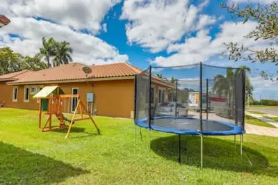 a playground in a yard with a house at Luxury Family Davie Rancho STR-6114 in Davie