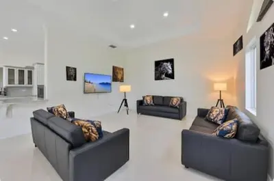 a living room with two couches and paintings on the wall at Luxury Family Davie Rancho STR-6114 in Davie