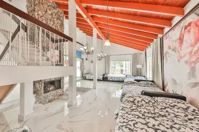 a bedroom with four beds and a fireplace at Haunted corner of Aventura Villa in Miami