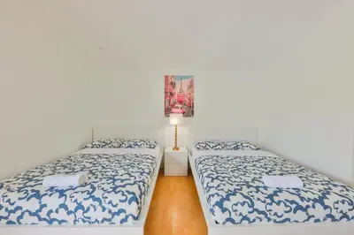 a bedroom with two beds and a lamp in it at Haunted corner of Aventura Villa in Miami