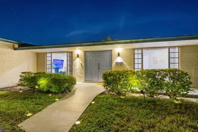 a house with a driveway leading to the front door at SUN VILLA Heated Pool Near Hard Rock & Beach in Hollywood