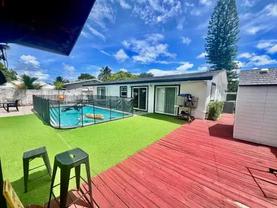 a backyard with a swimming pool and a wooden deck at Better Experience Property in Miramar