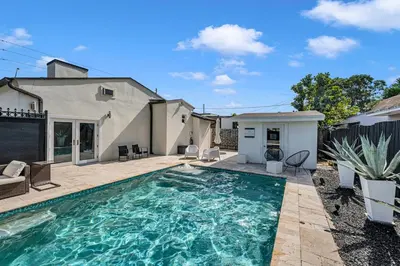 a swimming pool in the backyard of a house at Blue Heaven Poolside Retreat Brickell Sleeps 13 in Miami