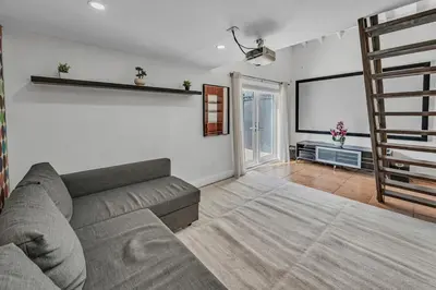 a living room with a couch and a tv at Blue Heaven Poolside Retreat Brickell Sleeps 13 in Miami