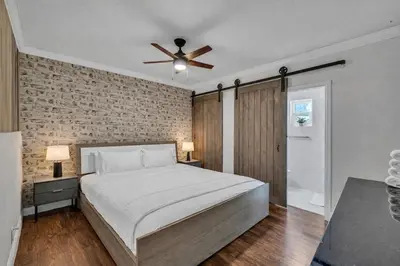 a bedroom with a bed and a ceiling fan at Blue Heaven Poolside Retreat Brickell Sleeps 13 in Miami