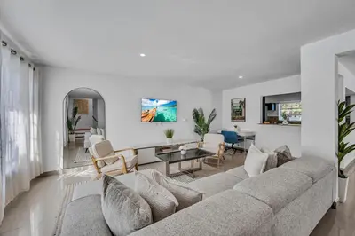 a living room with a couch and a table at The Blue Heaven Private Pool Hideaway Sleeps 11 in Golden Glades