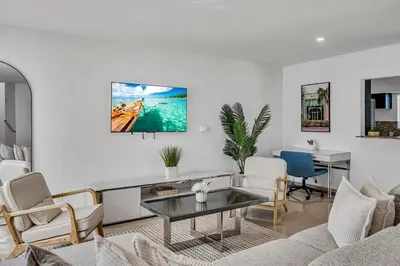 a living room with a couch and a table at The Blue Heaven Private Pool Hideaway Sleeps 11 in Golden Glades