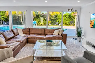 a living room with a couch and a glass table at Casa Sol in Richmond Heights
