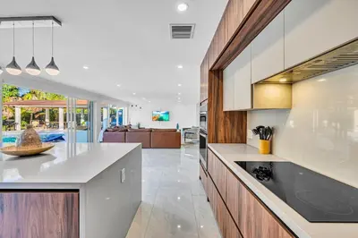 a kitchen with a counter top and a living room at Casa Sol in Richmond Heights