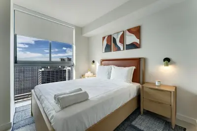 a bedroom with a large bed and a large window at Crosby Miami WTC 2BR 2BA High Floor Corner #3101 in Miami