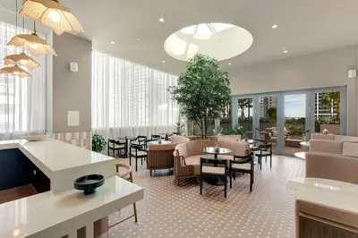 a lobby with tables and chairs and a restaurant at Crosby Miami WTC 1BR 1BA Chic Flawless New #2913 in Miami