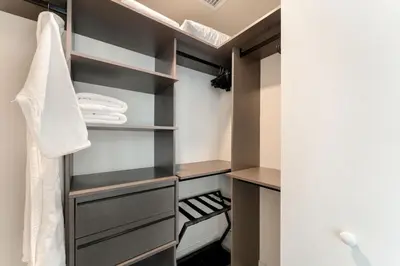 a walk in closet with black and gray shelves at Crosby Miami WTC 1BR 1BA Chic Flawless New #2913 in Miami