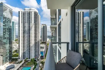 a balcony with a chair and a view of a city at Crosby Miami WTC 1BR 1BA Chic Flawless New #2913 in Miami
