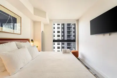 a bedroom with a bed and a flat screen tv at Crosby Miami WTC 1BR 1BA Chic Flawless New #2913 in Miami