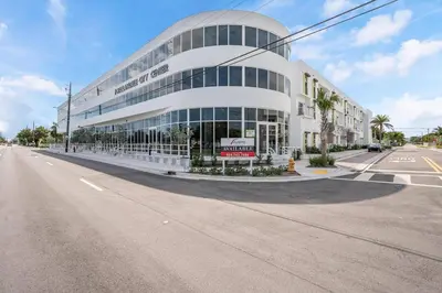 a large white building on the corner of a street at Coastal 2BR-2BA Oasis Beach Pool Parking EV Estation in Hallandale Beach