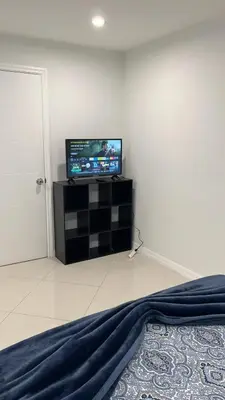 a room with a flat screen tv on a wall at Villa la Morada - Live stress-free in fully furnished, all-inclusive corporate housing! in Miami