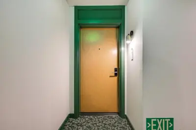 a green and yellow door in a hallway at Luxe High-Rise Living! Crosby Condo with Ocean View in Miami